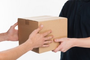 From hands to hands. Close-up of hands holding cardboard box whi